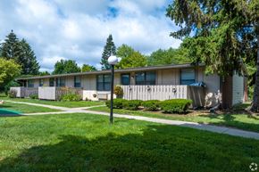 Sterling Heights apartment for rent - a white house with a yard and sidewalk in front of it