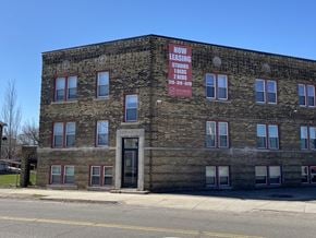 Detroit apartment for rent - an old brick building with a red sign on the side of it