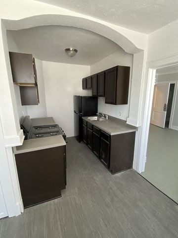 Detroit apartment for rent - a kitchen with a stove and a sink and a refrigerator