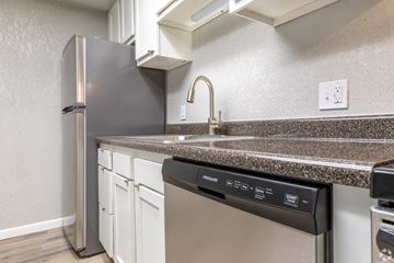 Sterling Heights apartment for rent - a kitchen with a dishwasher and a stainless steel refrigerator