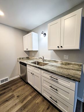 Ferndale apartment for rent - a kitchen with white cabinets and a counter top and a sink
