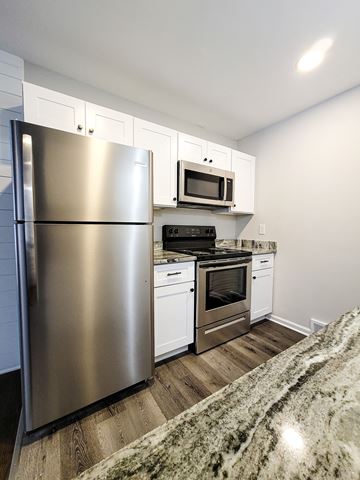 Ferndale apartment for rent - A modern kitchen with a stainless steel refrigerator and white cabinets.