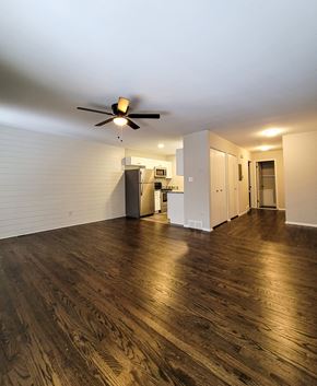 Ferndale apartment for rent - an empty living room with a ceiling fan and a kitchen