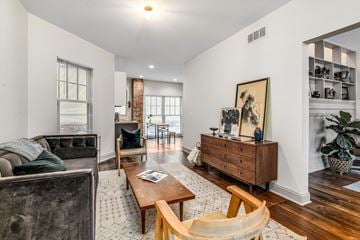 Detroit townhouse for rent - A living room with a grey couch, a wooden coffee table, and a painting on the wall.