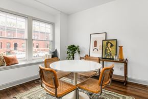 Detroit townhouse for rent - A white table with four chairs in front of a window.