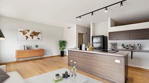 Detroit apartment for rent - a kitchen and living room with white walls and hardwood floors