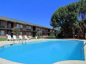 Riverview apartment for rent - a large blue pool in front of a building