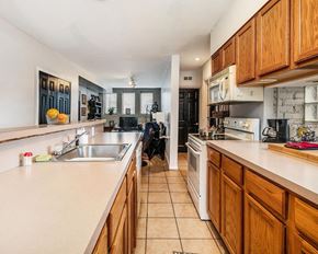 Detroit apartment for rent - a kitchen with wooden cabinets and white appliances