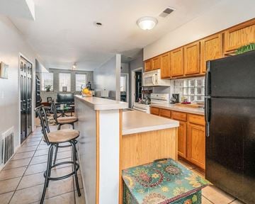 Detroit apartment for rent - a kitchen with a counter and a bar with stools