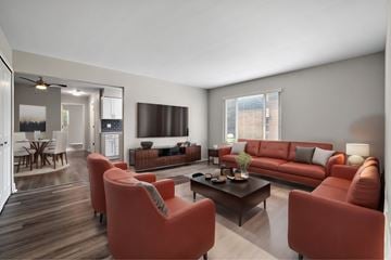 Riverview apartment for rent - A living room with a red couch and a coffee table.