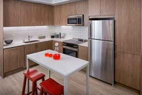 Las Vegas apartment for rent - Our kitchens feature stainless steel appliances, tile backsplash and wood-grain cabinets