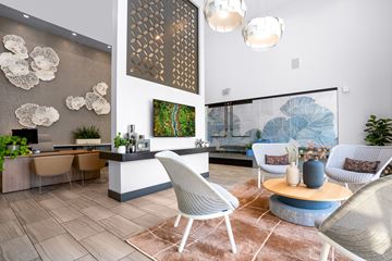 Brea apartment for rent - A modern living room with a dining area and a large painting on the wall.