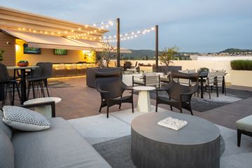 Brea apartment for rent - A patio with a table and chairs is set up for an evening of relaxation.