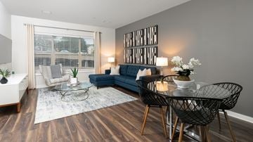 Malden apartment for rent - A living room with a blue couch and a glass table.
