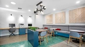Portland apartment for rent - A modern office space with a blue accent wall and wooden furniture.