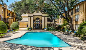 Dallas apartment for rent - A swimming pool surrounded by a fence and trees.