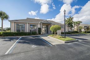 Vero Beach apartment for rent - A building with a parking lot in front of it.