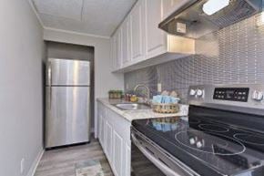 Tampa apartment for rent - A kitchen with a stove top oven and a refrigerator.