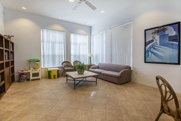 Vero Beach apartment for rent - A living room with a couch, chair, and a painting on the wall.