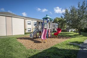 Vero Beach apartment for rent - A playground with a slide and a red chair.