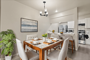 Dallas apartment for rent - A dining room with a wooden table set for two with a view of the ocean.