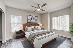Lakewood apartment for rent - A bedroom with a large bed and a ceiling fan.