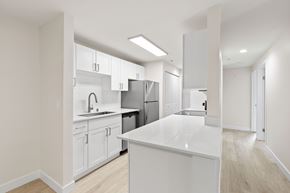 Everett apartment for rent - A modern kitchen with white cabinets and appliances.