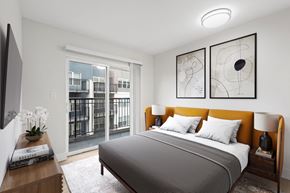 Seattle apartment for rent - a bedroom with a large window and a bed with a yellow headboard