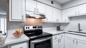 Scottsdale apartment for rent - a kitchen with white cabinets and a bowl of fruit on the counter