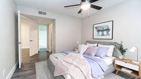 Scottsdale apartment for rent - a bedroom with a ceiling fan and hardwood flooring