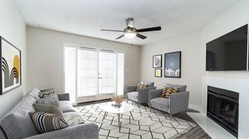 Scottsdale apartment for rent - a living room with couches and a ceiling fan and a fireplace