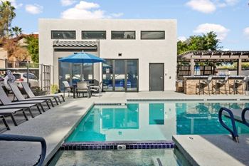 Two swimming pool areas with relaxing loungers