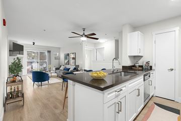 Seattle apartment for rent - a kitchen with an island and a living room with a couch