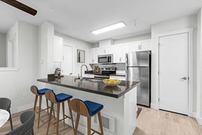 Seattle apartment for rent - a kitchen with a large center island with a breakfast bar and three stools