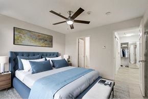 Newcastle apartment for rent - a bedroom with a large bed and a ceiling fan