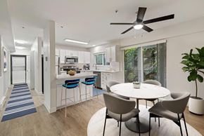 Newcastle apartment for rent - an open kitchen and dining area with a table and chairs