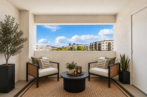 Tempe apartment for rent - A patio with two chairs, a table, and a potted plant.