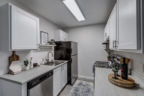 Renton apartment for rent - a kitchen with white cabinets and stainless steel appliances
