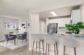 Renton apartment for rent - an open kitchen and dining room with a table and chairs