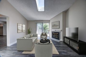 Lakewood apartment for rent - A modern living room with a grey sofa and a fireplace.