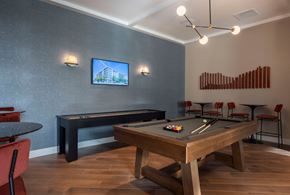 Fremont apartment for rent - A room with a pool table and a television mounted on the wall.