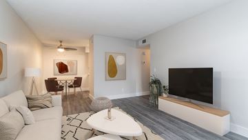 Mesa apartment for rent - an open living room and dining room with a couch and a tv
