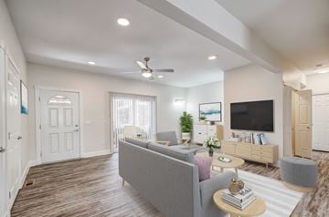Lakewood apartment for rent - A living room with a grey couch and a television on the wall.