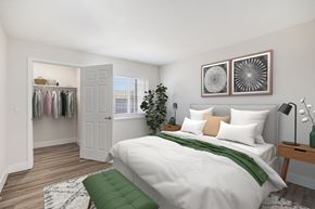 Centennial apartment for rent - A bedroom with a white bed and a green pillow.