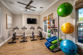 Temecula apartment for rent - a home gym with exercise equipment and a ceiling fan