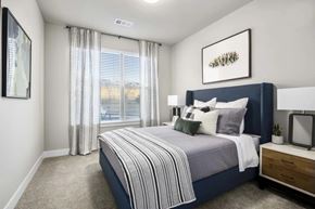 Golden apartment for rent - A bedroom with a large bed and a window with curtains.