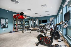 Golden apartment for rent - A gym with a variety of exercise equipment including stationary bikes and weight racks.