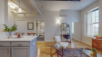 Troy apartment for rent - a living area with a kitchen and a living room with a table and chairs