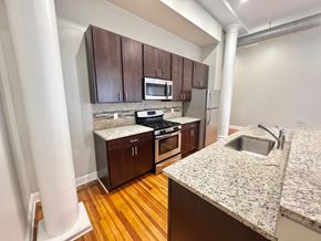 Albany apartment for rent - a kitchen with wood flooring and granite counter tops and