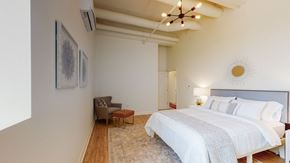 Schenectady apartment for rent - a bedroom with a large bed and a ceiling fan